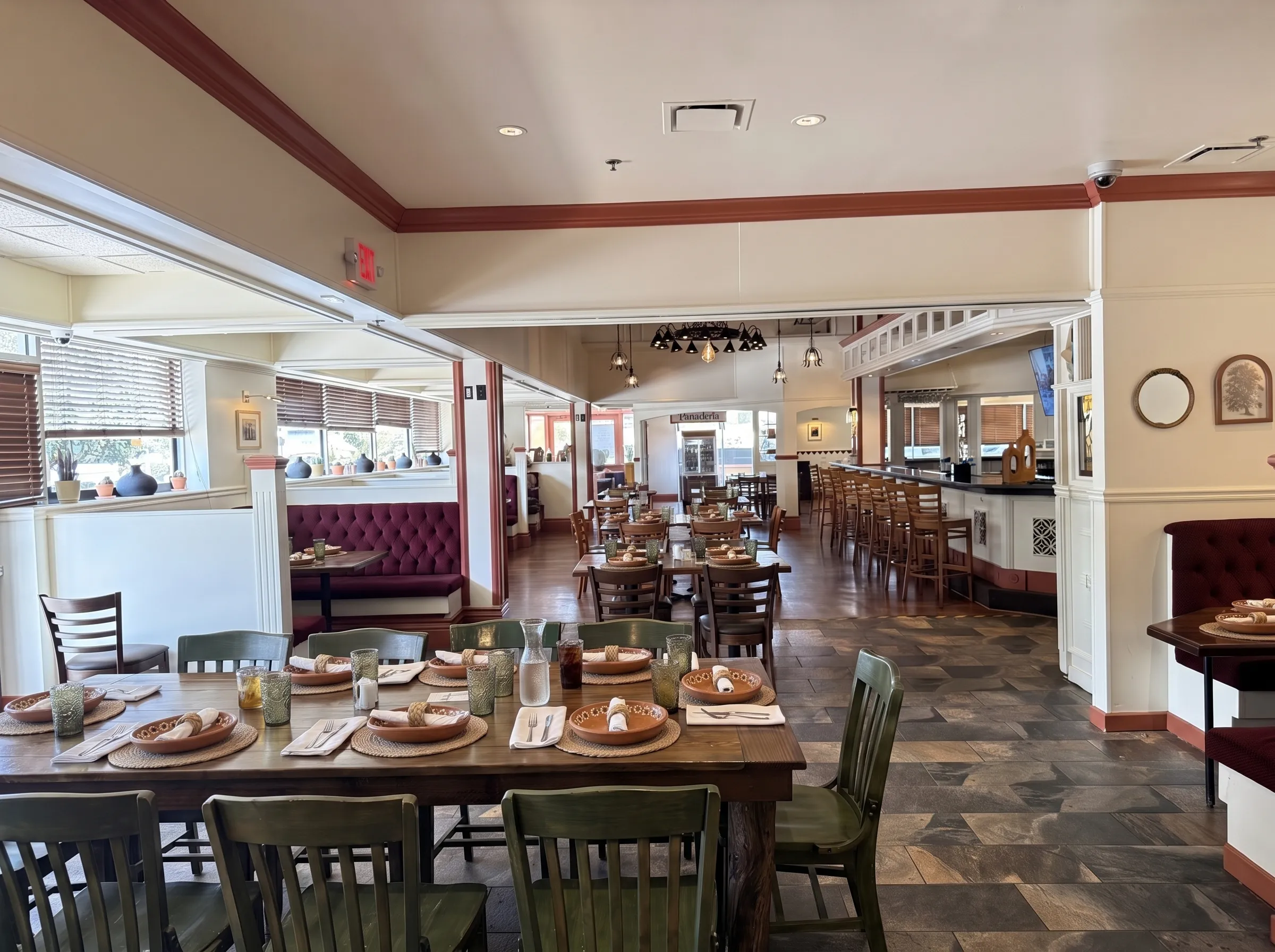 The Panfila dining room set with terracotta plates, woven placemats and smoky olive glasses