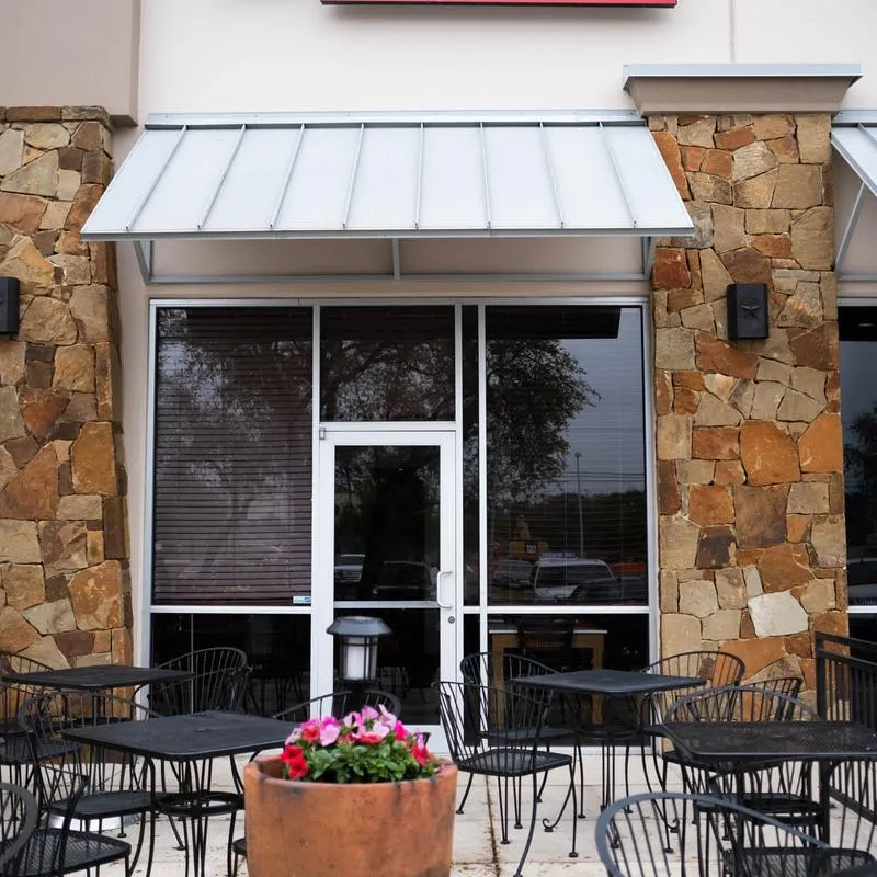 The patio seating outside Panfila under the awning