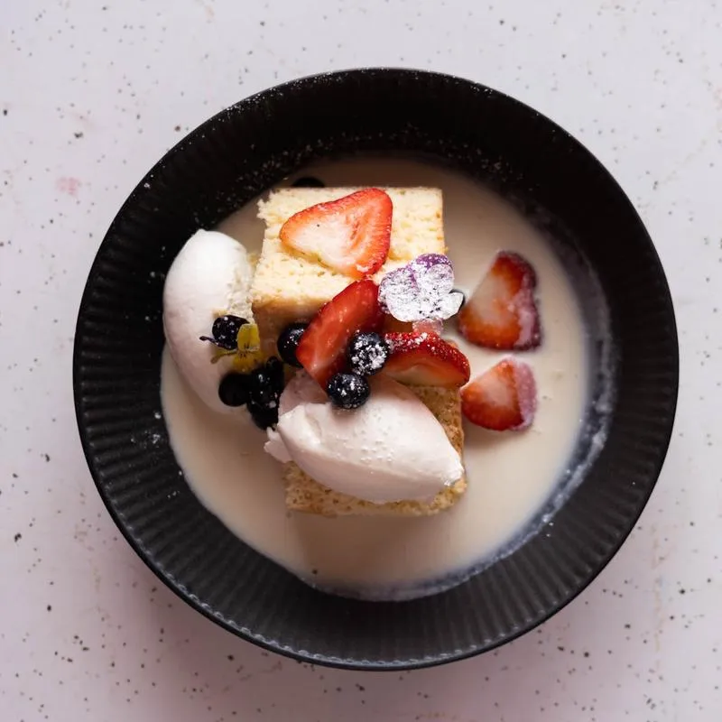 Tres leches cake with ice cream and berries